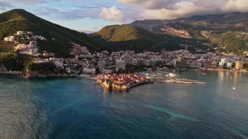 Video - Aerial drone view over Budva, capturing the coastline, the marina, and the Old Town. Montenegro