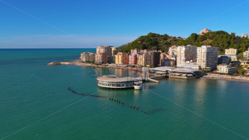 Video - Aerial drone view of the iconic circular Rotonda building extending over the turquoise waters of the Adriatic Sea in Durres, Albania