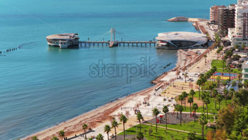 Video - Aerial drone view of the iconic circular Rotonda building extending over the turquoise waters of the Adriatic Sea in Durres, Albania