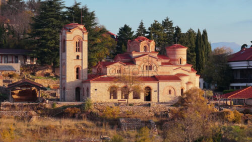 Video - Aerial drone view of the restored St. Clement and Panteleimon Church at Plaosnik, showcasing its Byzantine architecture surrounded by historical ruins. Ohrid, North Macedonia