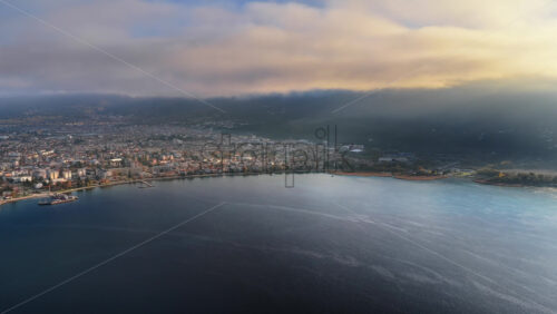 Video - Aerial drone view of a Galichica mountain ridge rising above a sea of clouds, with soft layers of fog covering the valley below