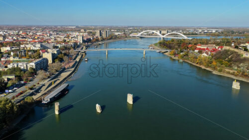 Video - Aerial drone view of Novi Sad's skyline with the Danube River and its bridges in the foreground