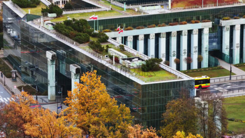 Video - Aerial drone view of the Supreme Court of Poland featuring its distinctive glass structure and green rooftop gardens, located next to Krasinski Square and the Warsaw Uprising Monument
