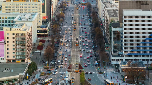 Video - Warsaw, Poland - October 30, 2025: Aerial drone view of heavy traffic, trams, and pedestrians at the intersection of Marszalkowska Street and Swietokrzyska Street, one of central main transit corridors