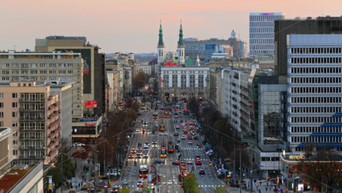 Video - Warsaw, Poland - October 30, 2025: Aerial drone view of Marszalkowska Street heading south toward Plac Konstytucji and the iconic MDM Hotel with its post war Socialist Realist architecture