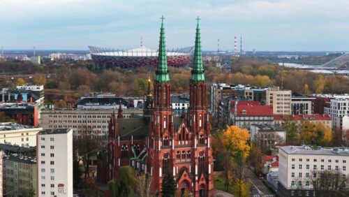 Video - Warsaw, Poland - October 31, 2025: Aerial drone view of the facade of St. Florian Cathedral in Praga, featuring its brickwork and symmetrical Gothic design
