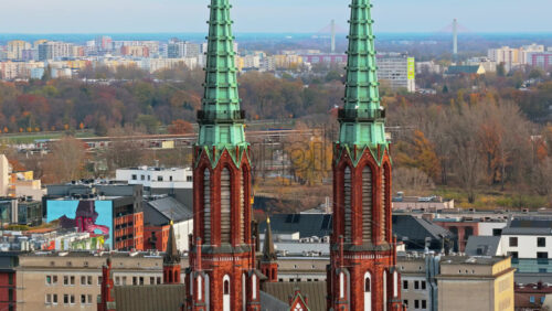 Video - Warsaw, Poland - October 31, 2025: Aerial drone view of the facade of St. Florian Cathedral in Praga, featuring its brickwork and symmetrical Gothic design