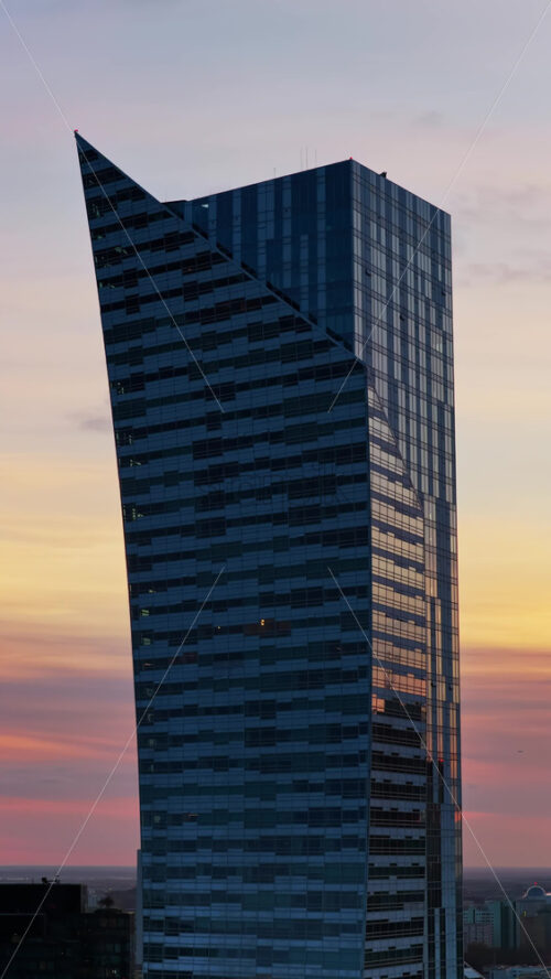 Video - Aerial drone view of the distinctive angular Skyliner skyscraper, located at Rondo Daszynskiego in the rapidly developing Warsaw business district. Vertical