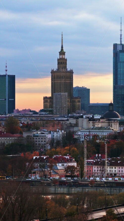 Video - Warsaw, Poland - October 31, 2025: Aerial drone view of the city's central skyline including the Palace of Culture, Warsaw Spire, and assorted modern towers. Vertical