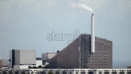 Video - CopenHill waste to energy power plant with smoke coming from the chimney. Copenhagen, Denmark