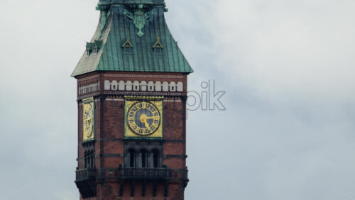 Video - Red brick tower of Copenhagen city hall standing against a cloudy sky. Denmark