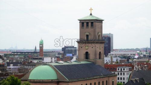 Video - Copenhagen, Denmark - August 4, 2025: Cityscape showing the neoclassical Vor Frue Kirke dome and tower against the urban skyline