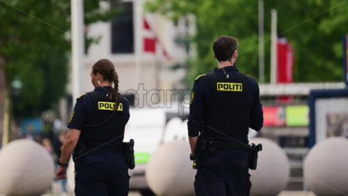 Video - Copenhagen, Denmark - August 4, 2025: Danish police officers standing on patrol in a city providing law enforcement and security