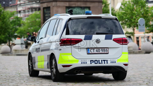 Video - Copenhagen, Denmark - August 4, 2025: Police vehicle parked on cobblestone street providing security and law enforcement in city