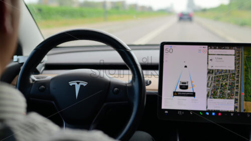 Video - Copenhagen, Denmark - August 4, 2025: Person driving Tesla electric vehicle using an advanced driver assistance system on a highway