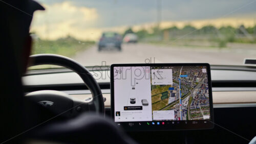 Video - Copenhagen, Denmark - August 4, 2025: Person driving Tesla electric vehicle using an advanced driver assistance system on a highway