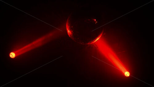 Video - Disco ball reflecting bright red light beams, creating a vibrant dance party atmosphere