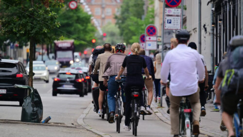 Video - Copenhagen, Denmark - August 5, 2025: Cyclists riding bikes on a city street, illustrating sustainable urban transportation