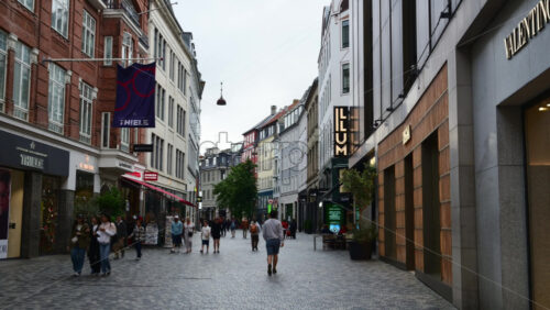 Video - Copenhagen, Denmark - August 3, 2025: Shoppers enjoying a stroll along the famous Stroget shopping street filled with high end brands