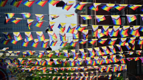 Video - Progress pride flags hanging across a city street symbolizing community celebration and inclusion. Copenhagen, Denmark