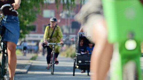 Video - Copenhagen, Denmark - August 6, 2025: Diverse group of cyclists waiting to cross an urban street