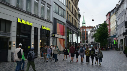 Video - Copenhagen, Denmark - August 3, 2025: Shoppers enjoying a stroll along the famous Stroget shopping street filled with high end brands