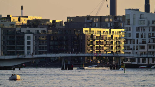 Video - People cycling and walking on Lille Langebro bridge over Copenhagen harbor at sunset