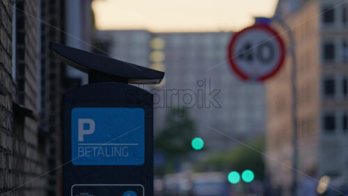 Video - Parking meter displaying ''Betaling'' meaning payment in a city street scene at sunset. Copenhagen, Denmark