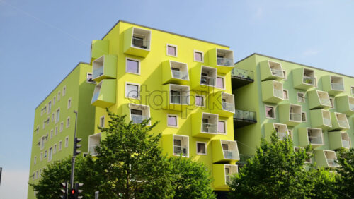 Video - Modern residential buildings showing striking lime green and pastel green facades with geometric cube balconies. Copenhagen, Denmark