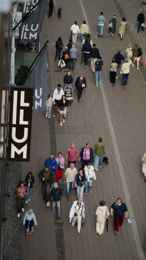 Video - Copenhagen, Denmark - August 6, 2025: Busy pedestrian street with many people walking and shopping in a European city