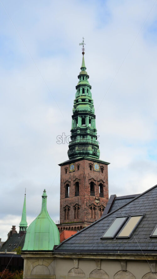 Video - Copenhagen, Denmark - August 6, 2025: Nikolaj Kunsthal, a historic former church, features a prominent brick tower with a green copper spire