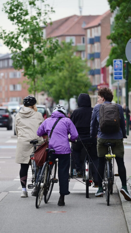 Video - Copenhagen, Denmark - August 7, 2025: People cycling on a city street, promoting urban commuting and sustainable transportation