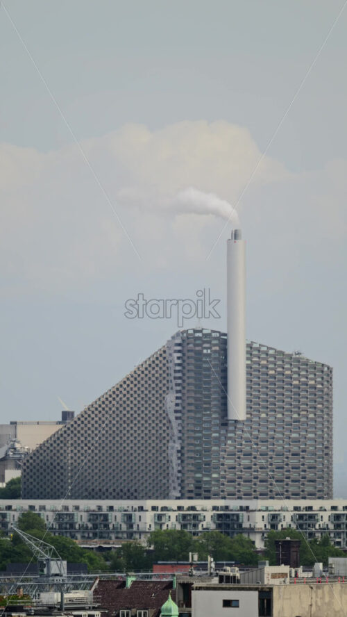 Video - Copenhill waste to energy plant with ski slope above historic buildings in Copenhagen, Denmark