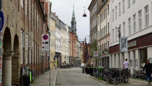 Video - Copenhagen, Denmark - August 3, 2025: Urban street scene in Copenhagen with a variety of architectural styles and a parked bikes
