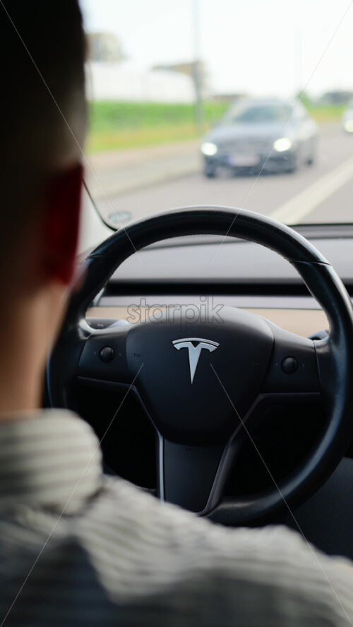 Video - Copenhagen, Denmark - August 7, 2025: Driver navigating Tesla electric car on a road trip. Autonomous driving