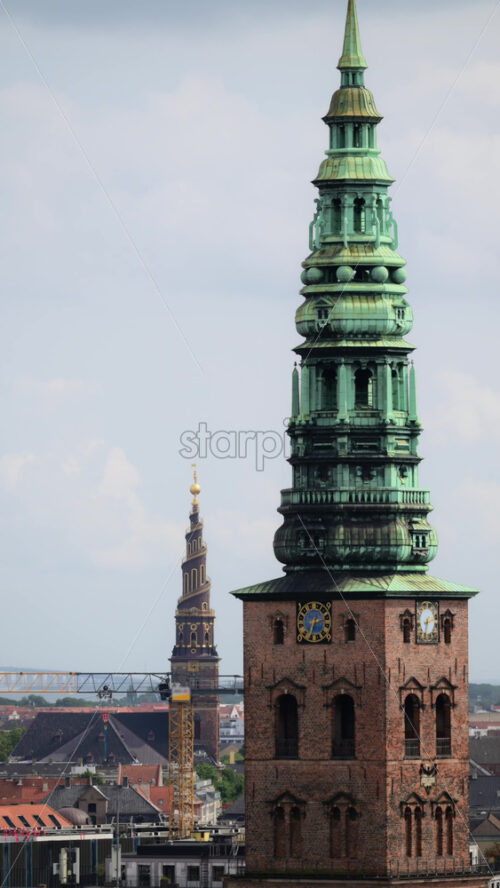 Video - Copenhagen cityscape showing historical spires of a church under a cloudy sky. Copenhagen, Denmark