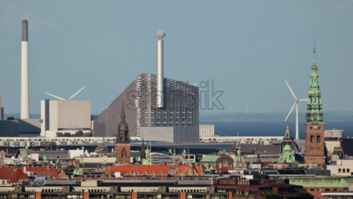 Video - Iconic Copenhill waste to energy plant dominating the Copenhagen skyline with old city buildings and wind turbines. Copenhagen, Denmark