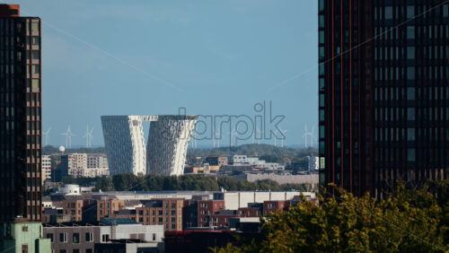 Video - Copenhagen cityscape featuring a modern building with wind turbines in the background. Denmark