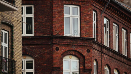 Video - Old brick building facade showing arched windows and a balcony. Copenhagen, Denmark