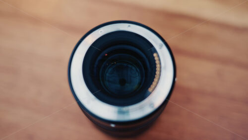 Video - Close up of a camera lens held in hand with soft background bokeh