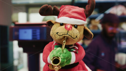 Video - Festive reindeer toy wearing a Santa hat and holding a saxophone