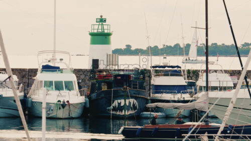 Video - Antibes, France - December 17, 2025: Front view of a moored boat featuring a painted shark mouth design on the hull