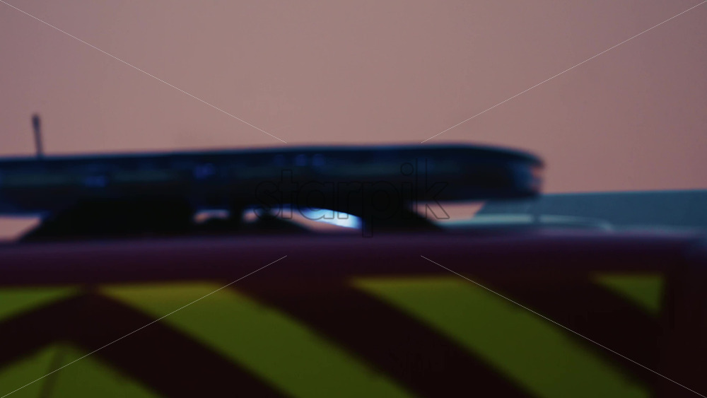 Video - Side view of a red ambulance moving through Antibes during dusk