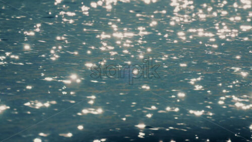 Video - Close up of sunlight reflections shimmering on gently moving sea water