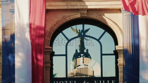 Video - French national flags waving on the facade of a historic building in southern France
