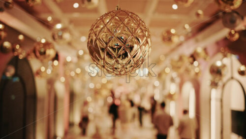 Video - Decorative Christmas ornament suspended under an illuminated arch with warm golden lighting