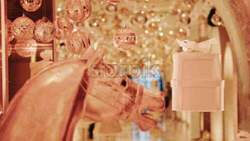 Video - Elegant close-up of a decorative horse statue displayed inside a warmly lit hallway filled with golden holiday lights and ornaments