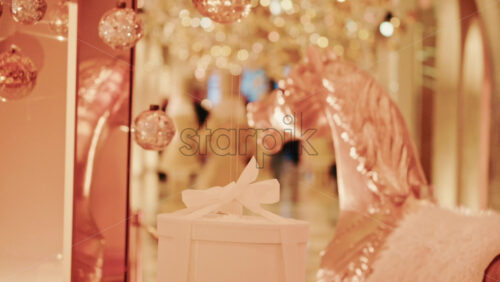 Video - Elegant close-up of a decorative horse statue displayed inside a warmly lit hallway filled with golden holiday lights and ornaments