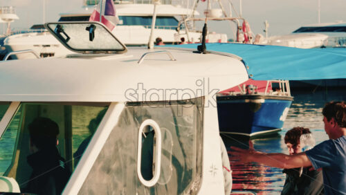 Video - Antibes, France - December 22, 2025: People boarding a small motorboat at a marina on the French Riviera