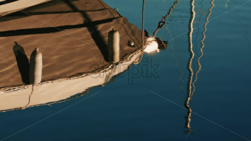 Video - Close up of a boat light reflecting on gently rippling water in a marina on the French Riviera